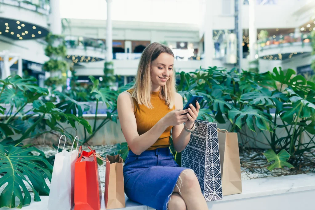 Retail customer sitting outdoors and connecting to Wi-Fi, promoting wi-fi vouchers for customer loyalty.