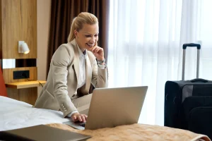 Business traveler using secure guest Wi-Fi in a hotel room with a laptop