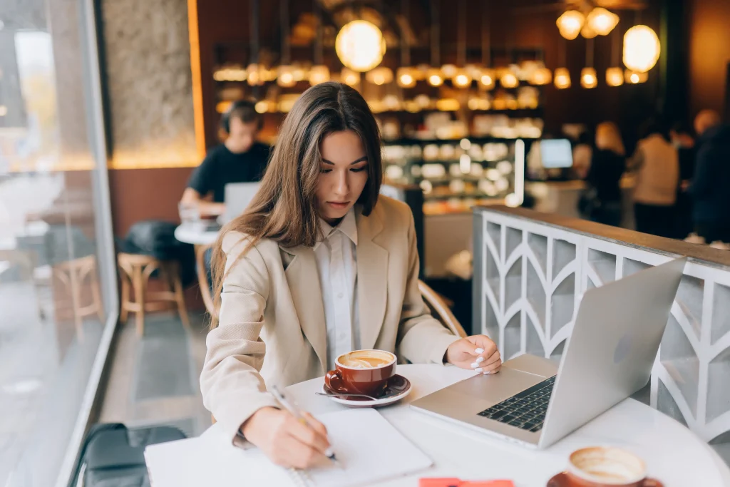 Customer working in cafe using secure guest WiFi network protected by AAA authentication and authorization controls