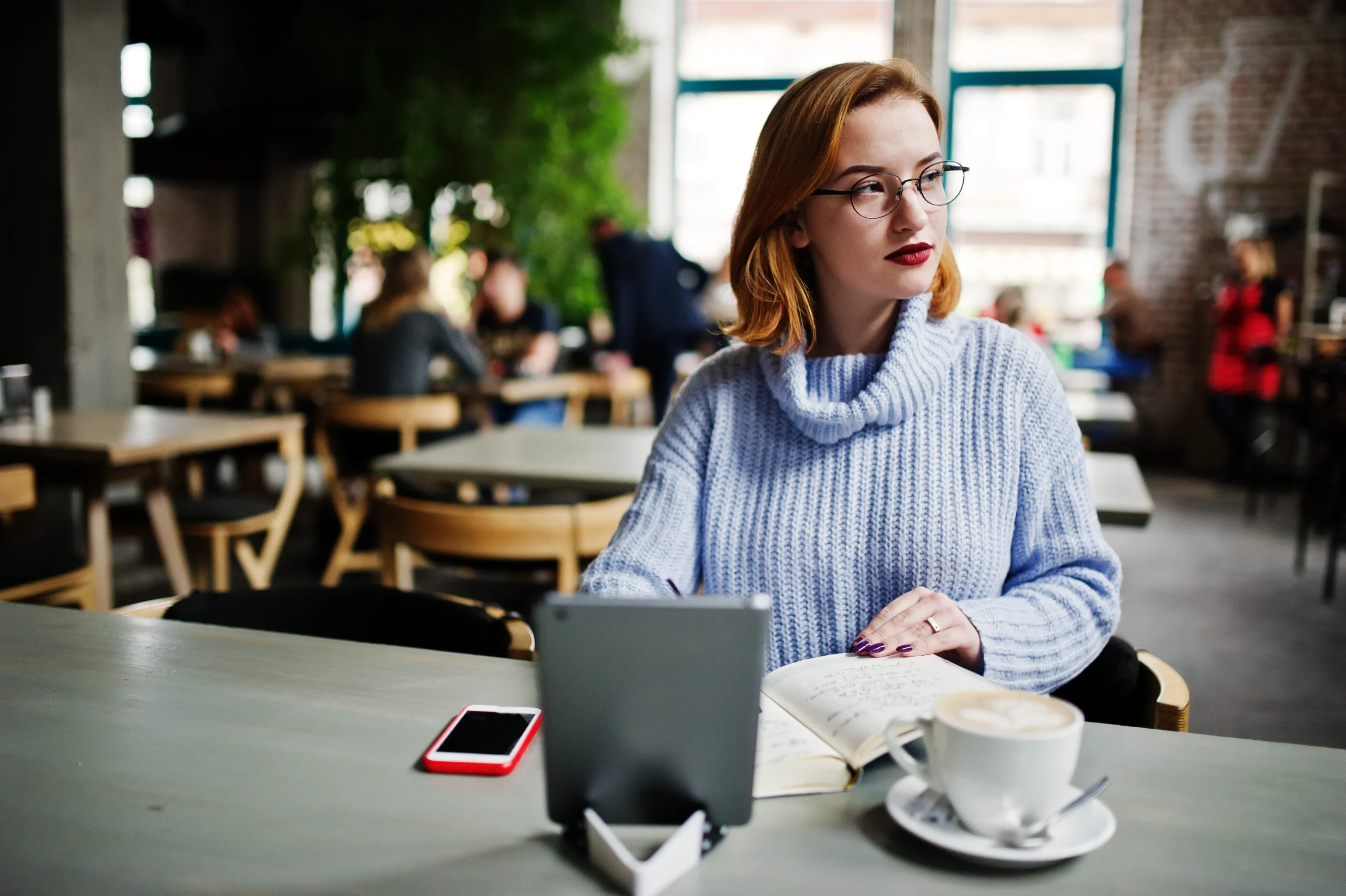 woman reading in cafe with coffee and tablet using wi-fi paid access